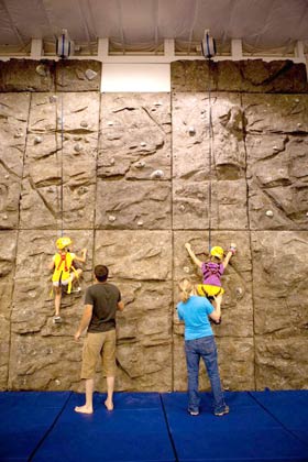 kids climbing rock textured wall